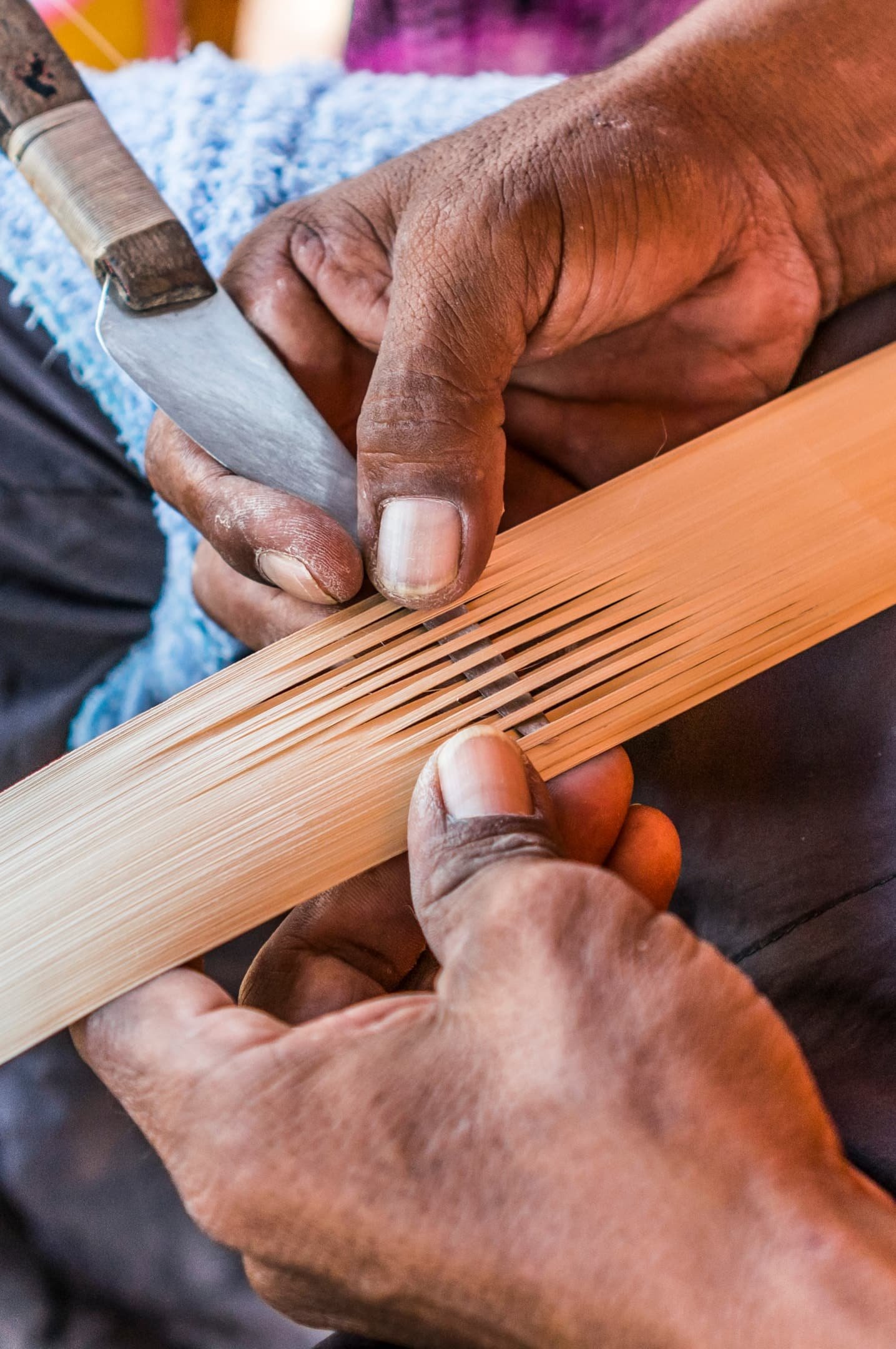 Wayuu indigenous man constructing a bamboo hat in the regional style of La Guajira, Colombia. While this is mostly a female profession in Wayuu communities, but some men also weave hats and textiles.