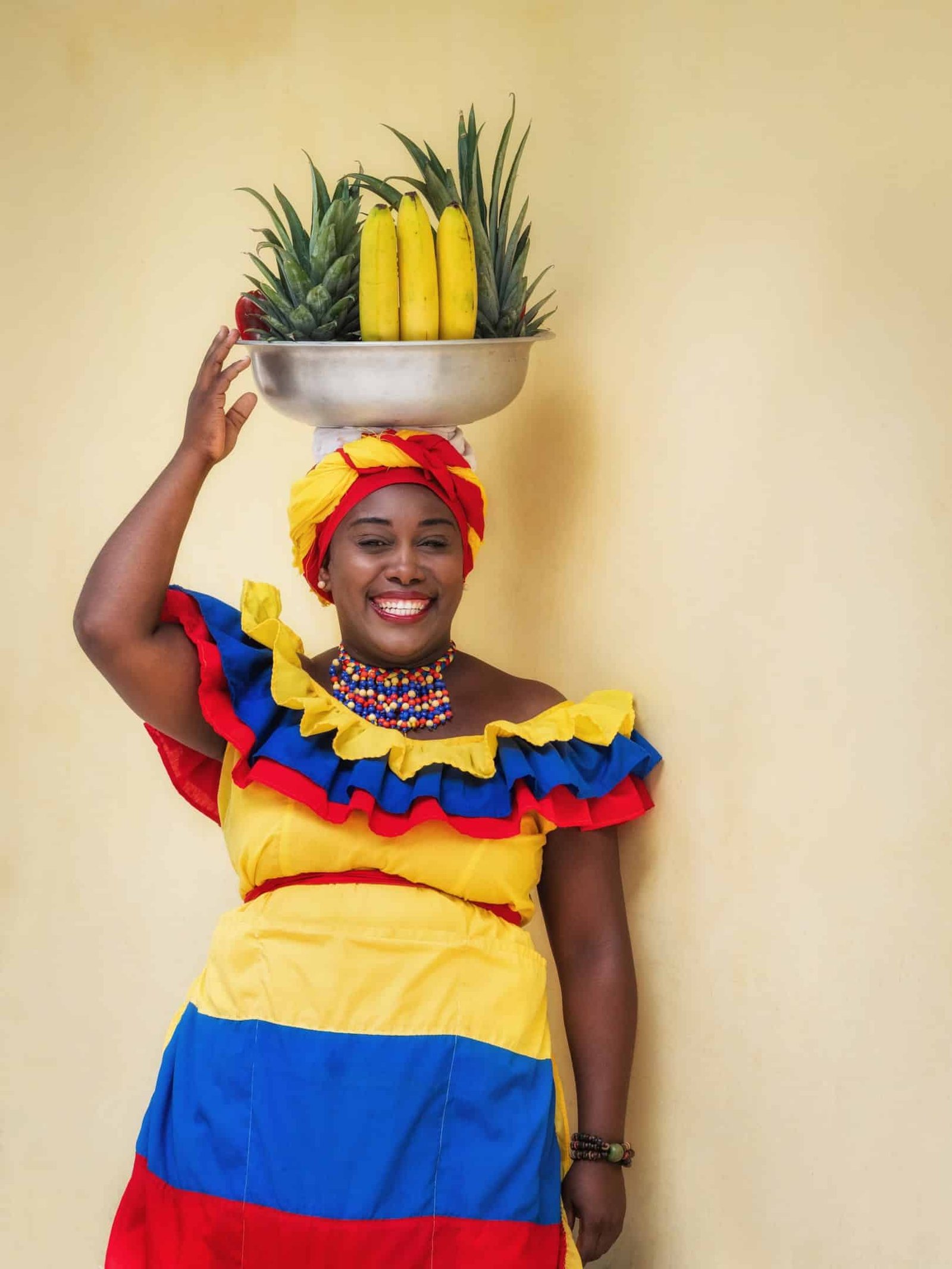 Colorful dress worn by fresh fruit street vendor aka Palenquera in the Old Town of Cartagena in Cartagena de Indias, Caribbean Coast Region, Colombia.